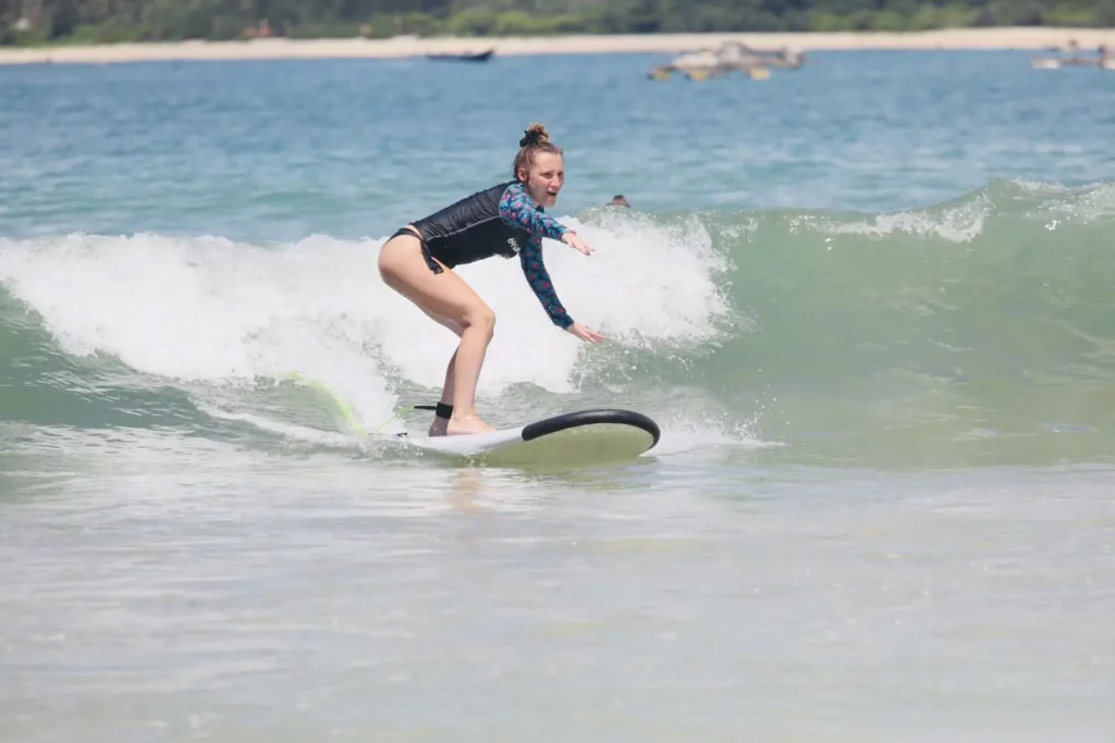 Surf lessons Kuta Lombok beginner package, girl catching her first wave