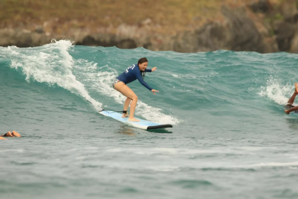 Surf lessons Kuta Lombok advanced package, girl catching a slightly larger wave